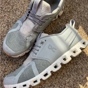 On Running Gray Athletic Shoes with Modern Design and Unique Sole