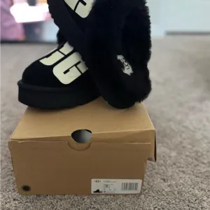 UGG Black Platform Slippers with Fluffy Trim
